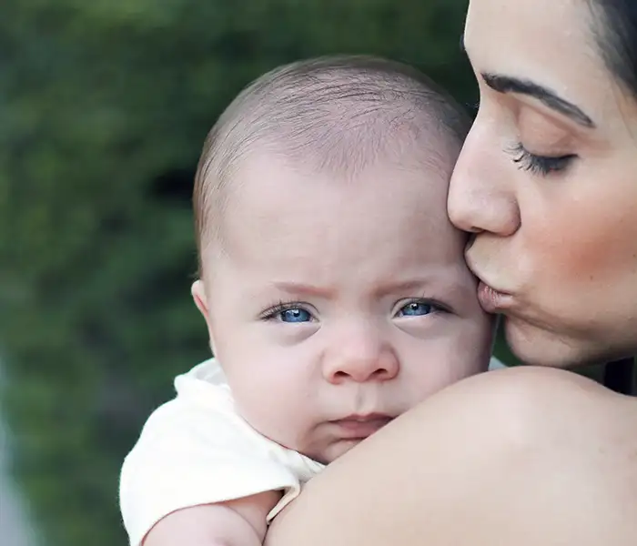 Young mother kissing her baby